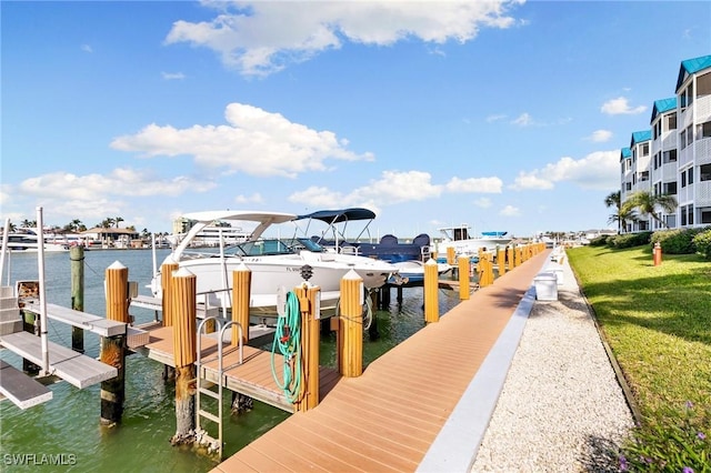 dock area with a yard and a water view