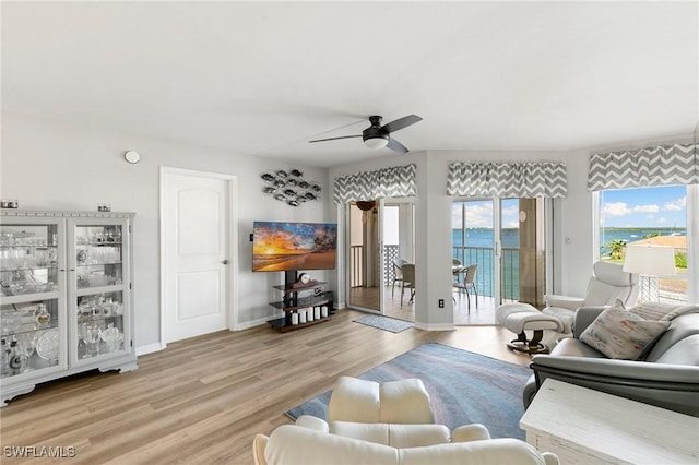 living room featuring ceiling fan and light hardwood / wood-style floors