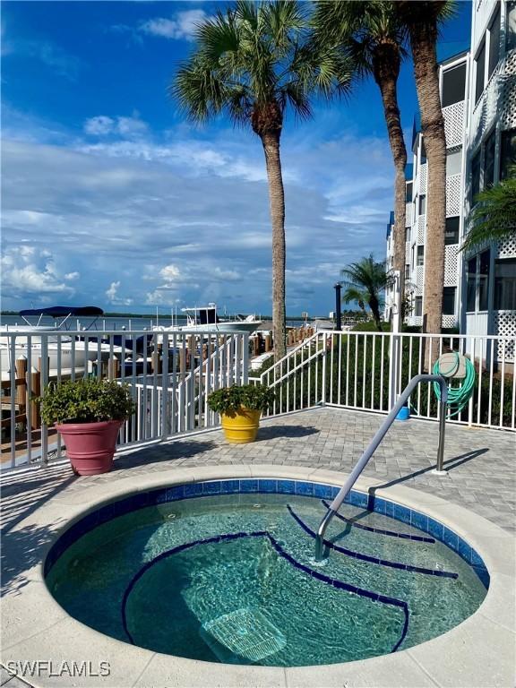 view of swimming pool with a hot tub