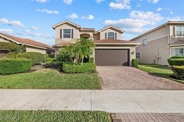 mediterranean / spanish home with a front yard and a garage