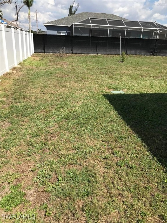 view of yard with a lanai