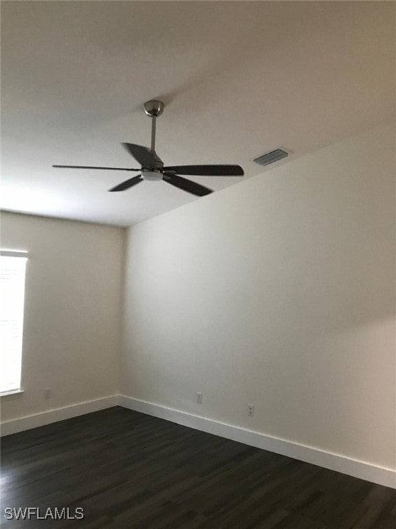 unfurnished room with dark hardwood / wood-style floors and ceiling fan