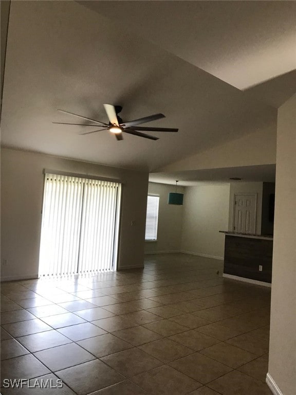 tiled spare room with ceiling fan and lofted ceiling