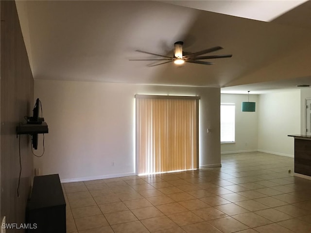 unfurnished living room featuring vaulted ceiling, ceiling fan, and light tile patterned flooring