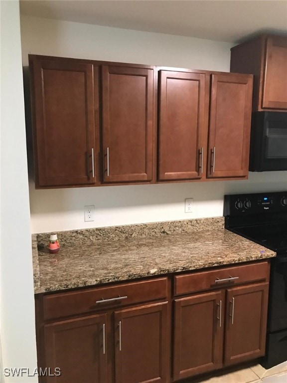 details featuring stone countertops and black appliances