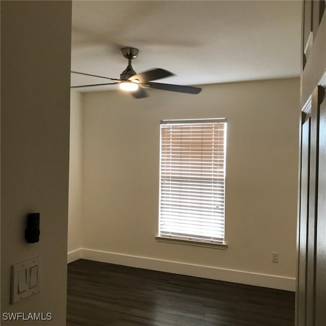 empty room featuring ceiling fan and dark wood-type flooring