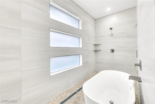 bathroom featuring shower with separate bathtub