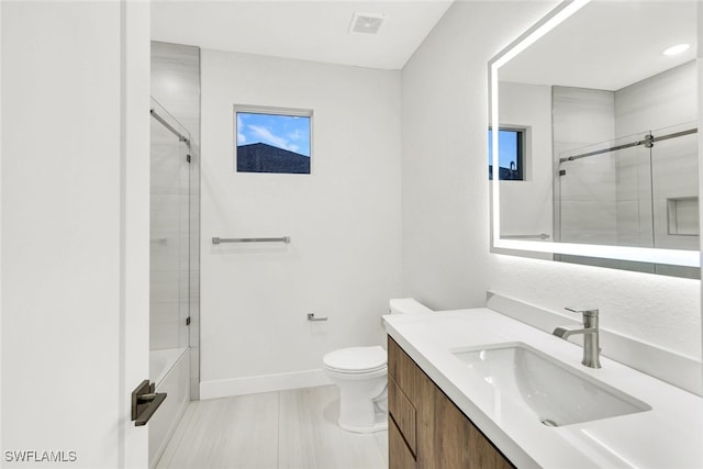 full bathroom with shower / bath combination with glass door, vanity, and toilet