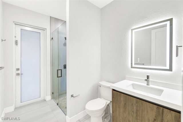 bathroom featuring tile patterned floors, vanity, an enclosed shower, and toilet