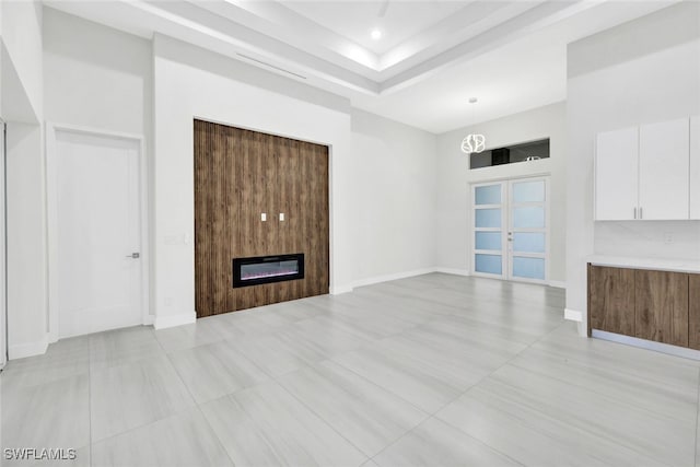 unfurnished living room with a fireplace and french doors