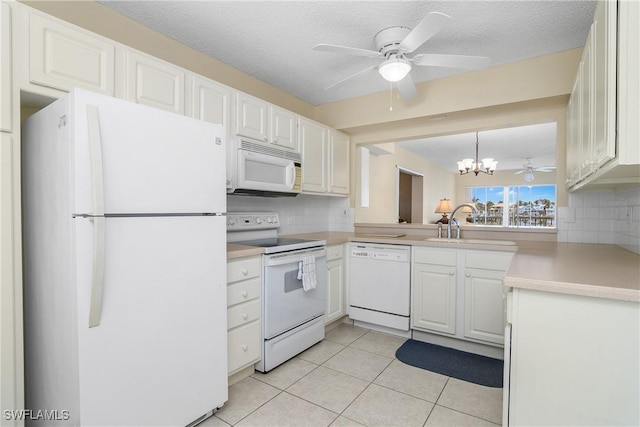 kitchen featuring decorative backsplash, white appliances, white cabinets, and light tile patterned flooring