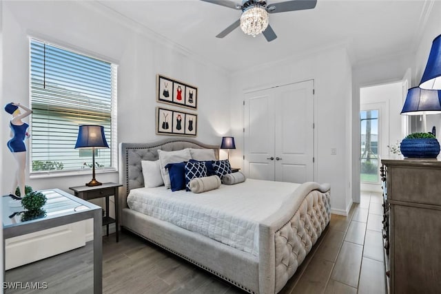 bedroom featuring multiple windows, ceiling fan, and hardwood / wood-style floors