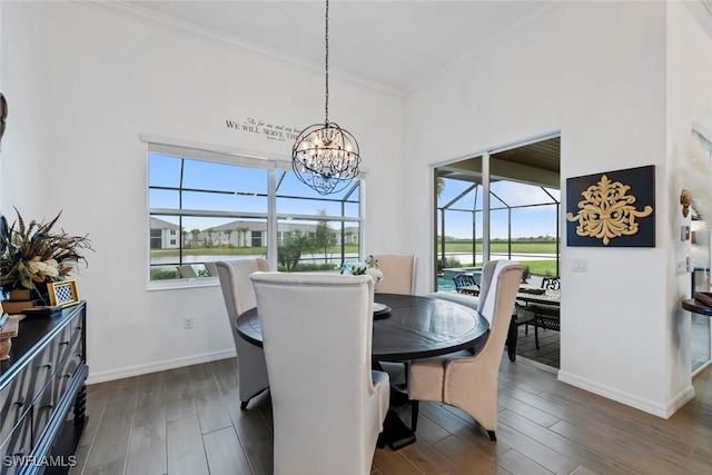 dining room featuring a notable chandelier, crown molding, and dark wood-type flooring