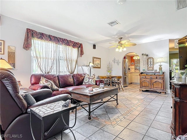 tiled living room featuring ceiling fan