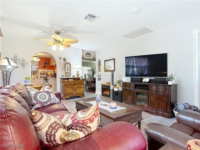 tiled living room with ceiling fan