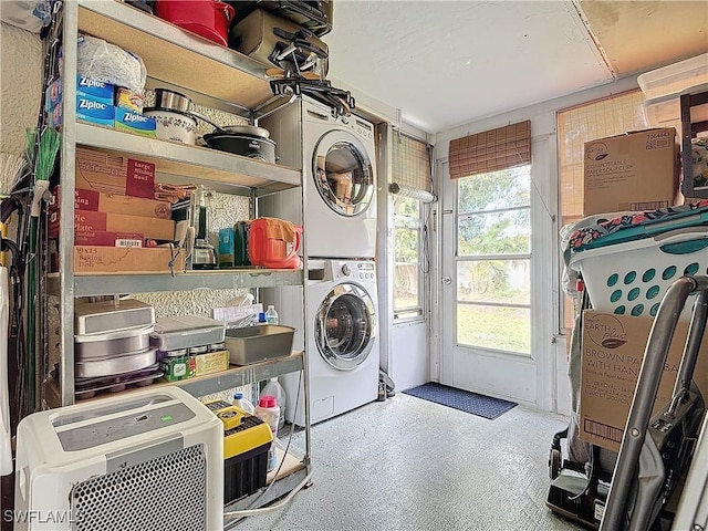 clothes washing area featuring stacked washer and dryer