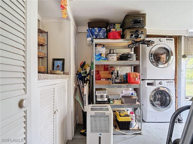 laundry room featuring stacked washer / drying machine