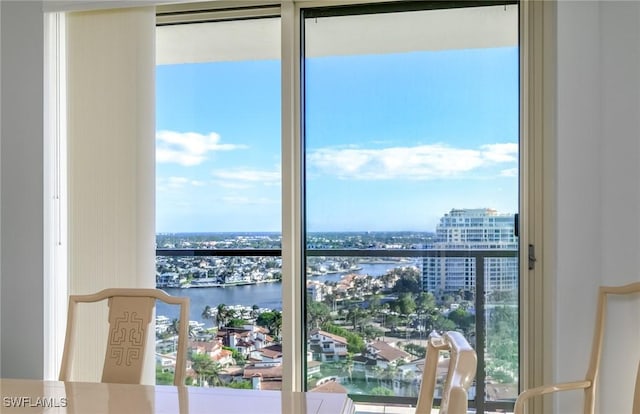 balcony featuring a water view and a city view