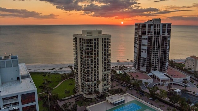 birds eye view of property with a water view and a view of city