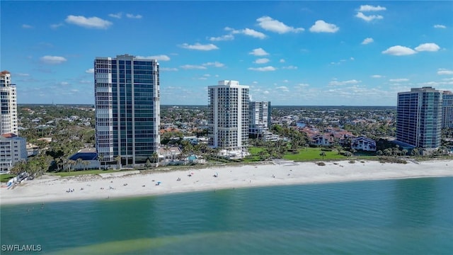 aerial view featuring a city view, a view of the beach, and a water view