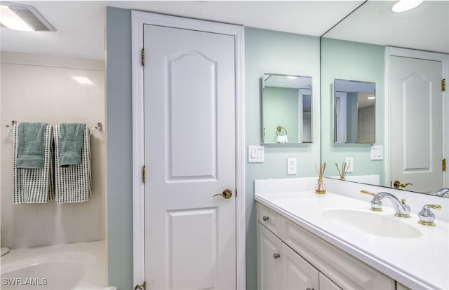 full bath with vanity and a bathing tub