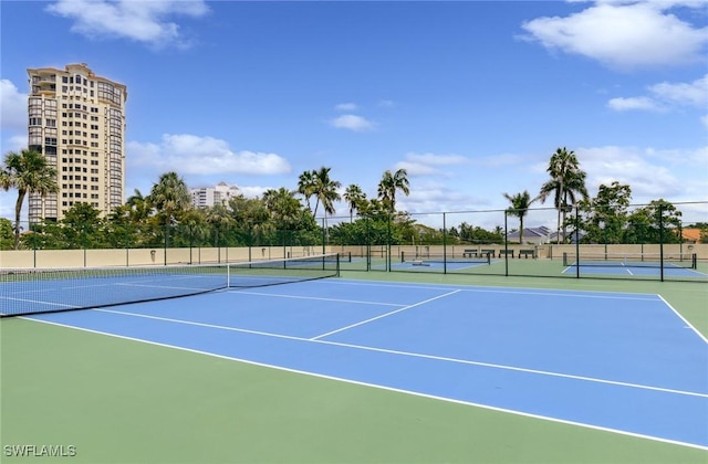 view of sport court featuring fence