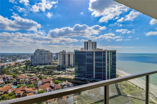 balcony featuring a water view and a view of the beach