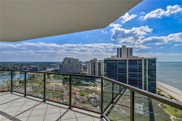 balcony with a water view and a view of city