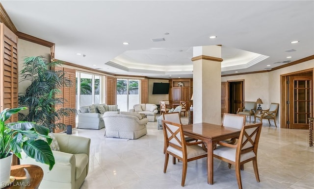 dining room featuring ornate columns, recessed lighting, a tray ceiling, and ornamental molding