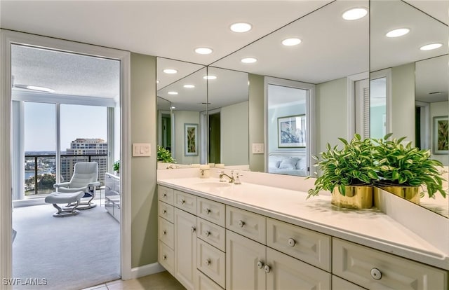 ensuite bathroom featuring recessed lighting, vanity, and connected bathroom