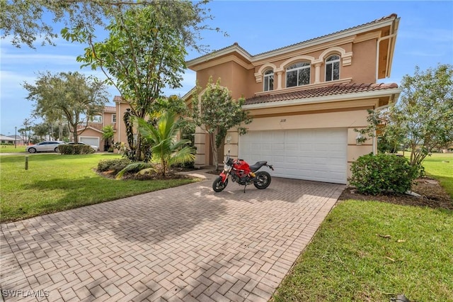 mediterranean / spanish house featuring a front lawn and a garage