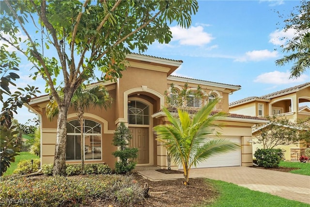 mediterranean / spanish house featuring a garage