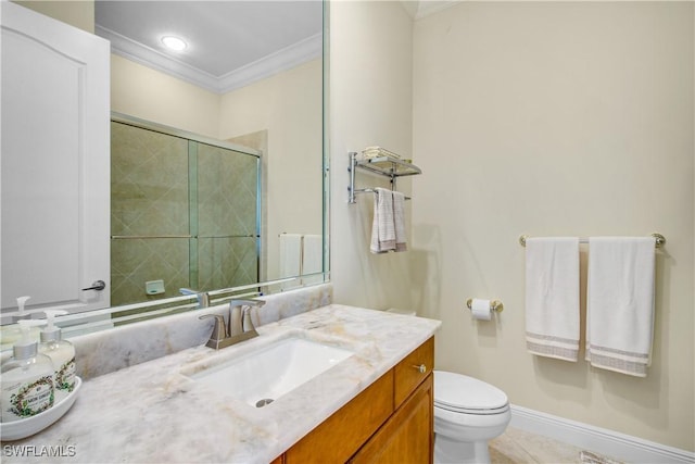 bathroom with vanity, a shower with door, crown molding, tile patterned flooring, and toilet