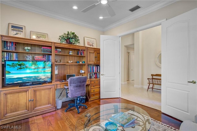 home office featuring ceiling fan, light wood-type flooring, and crown molding