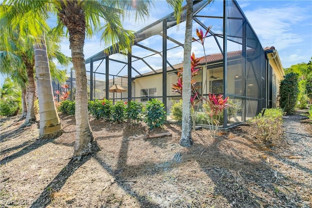 exterior space featuring ceiling fan and a lanai