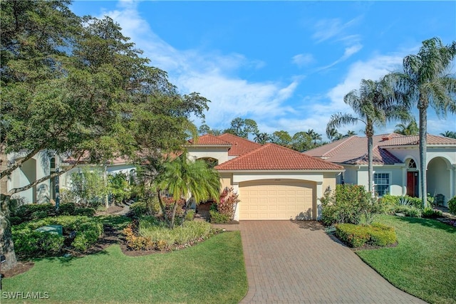 mediterranean / spanish home with a garage and a front lawn