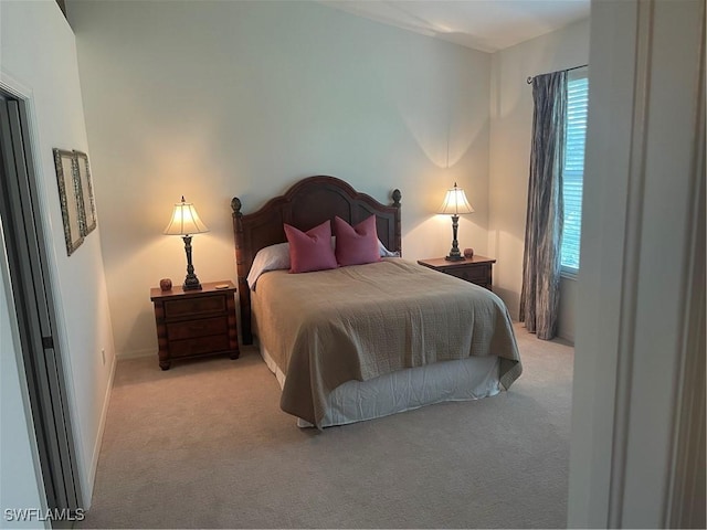 bedroom featuring multiple windows and light colored carpet