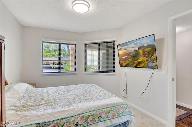 carpeted bedroom featuring a textured ceiling