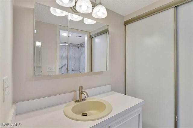 bathroom featuring vanity and a chandelier