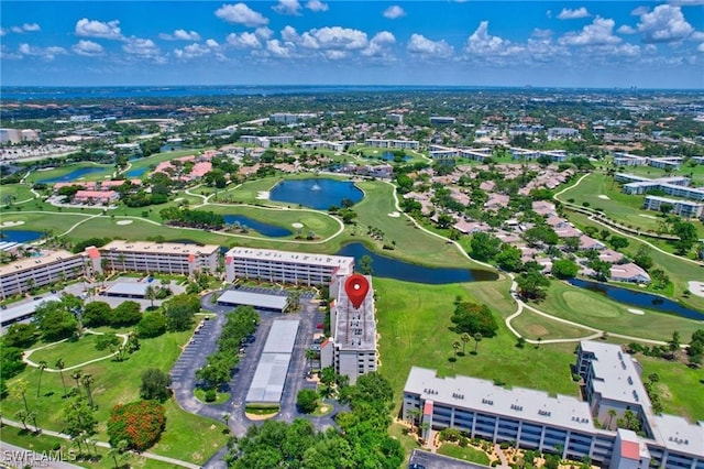 bird's eye view with view of golf course and a water view