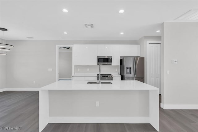 kitchen with sink, white cabinets, a spacious island, and appliances with stainless steel finishes