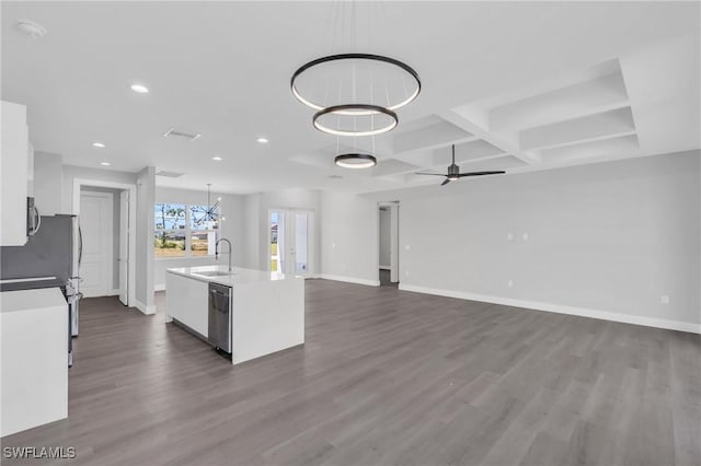 kitchen with a kitchen island with sink, sink, hanging light fixtures, ceiling fan, and white cabinetry