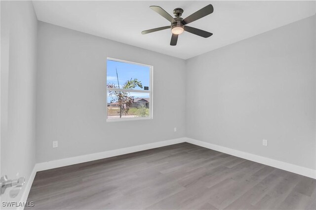 empty room with hardwood / wood-style floors and ceiling fan