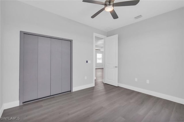 unfurnished bedroom featuring a closet, light hardwood / wood-style flooring, and ceiling fan