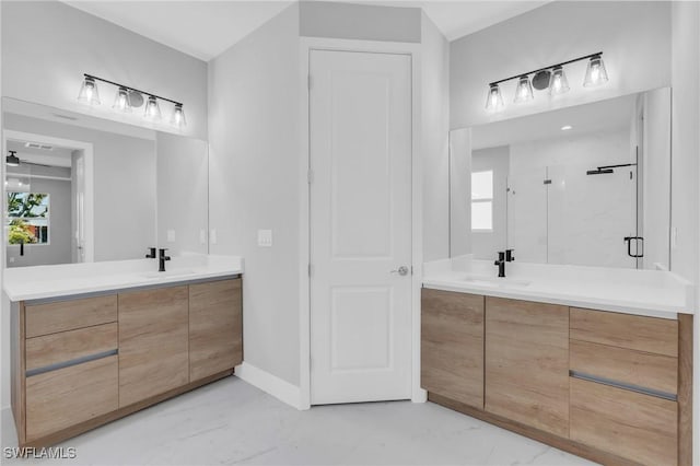 bathroom with vanity, a shower with door, and plenty of natural light