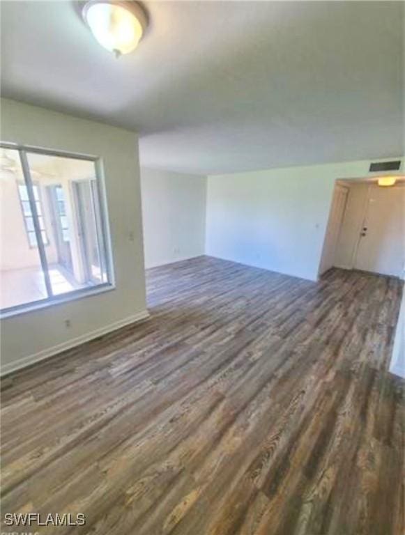 empty room with dark wood-type flooring