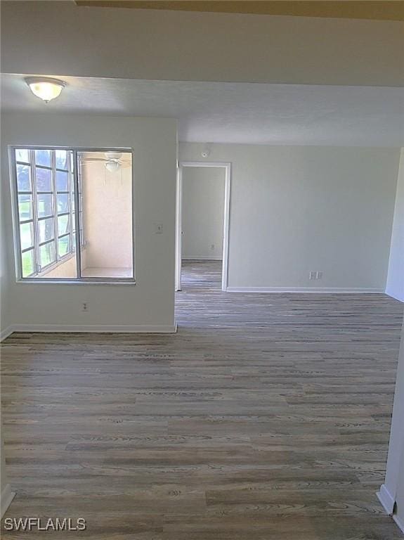 spare room with dark wood-type flooring