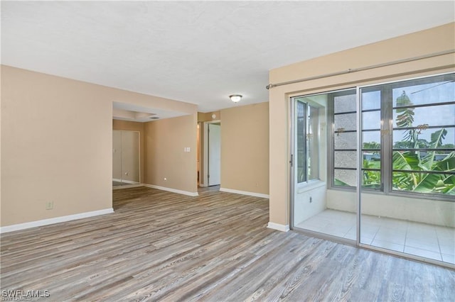 unfurnished room with light hardwood / wood-style floors