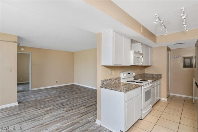 kitchen with stone counters, white cabinetry, light wood-type flooring, and white appliances