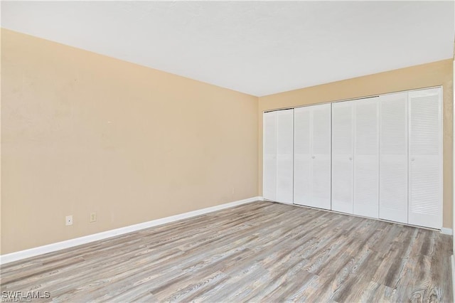 unfurnished bedroom featuring a closet and light hardwood / wood-style flooring